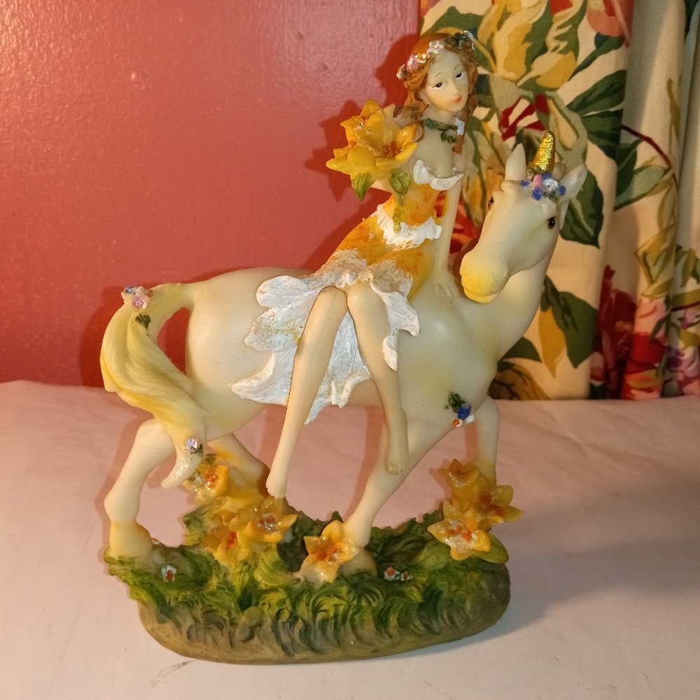FAIRY GIRL DRESSED IN BEAUTY SITTING ON A WHITE UNICORN OF BEAUTY STATUE